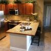 Kitchen Featuring Granite Tile Countertops with Bar and Granite Tile Backsplash in One Bedroom Model