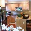 Kitchen Featuring Granite Countertops, Island with Bar and Stainless Steel Appliances in Two Bedroom Model